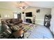 Inviting living room with vaulted ceilings, a comfortable couch, and a large TV at 201 Joe Gibson Dr, Gibsonville, NC 27249