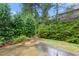 Inviting backyard featuring a patio and lush greenery, perfect for outdoor relaxation at 2012 Muirfield Ct, Elon, NC 27244
