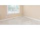 Bedroom featuring neutral walls and carpet, and a large window at 2012 Muirfield Ct, Elon, NC 27244