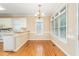 Charming breakfast nook features natural light and an elegant chandelier for Gathering meals at 2012 Muirfield Ct, Elon, NC 27244