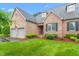 Beautiful brick home featuring an attached two-car garage and lush landscaping at 2012 Muirfield Ct, Elon, NC 27244