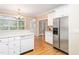 Bright and airy kitchen area, stainless steel refrigerator, and ample counter space for cooking at 2012 Muirfield Ct, Elon, NC 27244