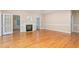 Open living room with hardwood floors features a fireplace and French doors leading to the backyard at 2012 Muirfield Ct, Elon, NC 27244
