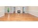 Open living room with hardwood floors features a fireplace and French doors leading to the backyard at 2012 Muirfield Ct, Elon, NC 27244