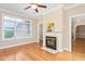 Bright sitting room with fireplace, ceiling fan and hardwood flooring, ideal for relaxing at 2012 Muirfield Ct, Elon, NC 27244