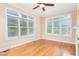 Bright sitting room filled with natural light, ceiling fan and hardwood flooring, ideal for relaxing at 2012 Muirfield Ct, Elon, NC 27244