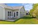 The back of the house features a door that goes to a concrete patio with table and chairs at 2117 Crockett Ridge Rd, Fuquay Varina, NC 27526