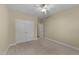 This bedroom features neutral paint, carpet flooring, a ceiling fan, and closet for ample storage at 2117 Crockett Ridge Rd, Fuquay Varina, NC 27526