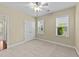 Comfortable bedroom with carpet, ceiling fan, and double closet, illuminated by natural light at 2117 Crockett Ridge Rd, Fuquay Varina, NC 27526