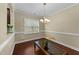 Bright dining room with a modern chandelier and dark wood floors; perfect for entertaining at 2117 Crockett Ridge Rd, Fuquay Varina, NC 27526