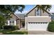 Charming home featuring a stone facade, neutral siding, a two-car garage, and manicured landscaping at 2117 Crockett Ridge Rd, Fuquay Varina, NC 27526