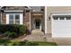 Inviting home entrance with stone accents, green landscaping, and a modern front door at 2117 Crockett Ridge Rd, Fuquay Varina, NC 27526