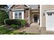 Close-up of home featuring stone facade, neat landscaping, and a welcoming front door at 2117 Crockett Ridge Rd, Fuquay Varina, NC 27526