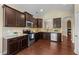 Stylish kitchen with dark wood cabinets, granite countertops, and stainless steel appliances at 2117 Crockett Ridge Rd, Fuquay Varina, NC 27526