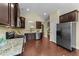 Spacious kitchen featuring dark cabinets, stainless steel appliances, and hardwood floors at 2117 Crockett Ridge Rd, Fuquay Varina, NC 27526