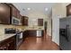 Bright kitchen featuring dark cabinets, granite countertops, and stainless steel appliances at 2117 Crockett Ridge Rd, Fuquay Varina, NC 27526