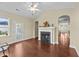 Cozy living room featuring dark wood flooring, a fireplace, bright walls, and backyard access at 2117 Crockett Ridge Rd, Fuquay Varina, NC 27526