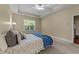 Spacious main bedroom with plush carpet, a ceiling fan, and a window overlooking the backyard at 2117 Crockett Ridge Rd, Fuquay Varina, NC 27526