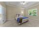 Main bedroom with a ceiling fan, carpet floors and large window for ample natural light at 2117 Crockett Ridge Rd, Fuquay Varina, NC 27526