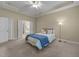 Comfortable main bedroom featuring plush carpet, a ceiling fan, and an ensuite bathroom at 2117 Crockett Ridge Rd, Fuquay Varina, NC 27526