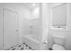 Bright bathroom featuring a tub-shower combo and stylish patterned tile floors at 212 Aubey Ln, Wake Forest, NC 27587