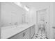 Bathroom featuring double sink vanity, quartz countertop, decorative tile flooring and modern fixtures at 212 Aubey Ln, Wake Forest, NC 27587