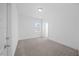 Bedroom with carpet, white walls, a window, and a door at 212 Aubey Ln, Wake Forest, NC 27587