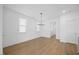 Bright bedroom with hardwood floors, two windows, and neutral paint at 212 Aubey Ln, Wake Forest, NC 27587