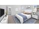 Stylishly staged bedroom with a king bed, elegant furnishings and bathroom entrance at 212 Aubey Ln, Wake Forest, NC 27587