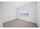 Bedroom with carpeted floor, white walls, a window, and a door at 212 Aubey Ln, Wake Forest, NC 27587