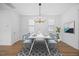 Dining room featuring a dining table, modern lighting and a large window to let in plenty of light at 212 Aubey Ln, Wake Forest, NC 27587