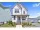 Charming two-story home with a covered front porch and beautifully landscaped front yard at 212 Aubey Ln, Wake Forest, NC 27587