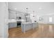 Open concept kitchen, island, stainless steel appliances and view to the living room and fireplace at 212 Aubey Ln, Wake Forest, NC 27587