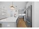 Modern kitchen featuring an island with seating, stainless steel appliances and light fixtures at 212 Aubey Ln, Wake Forest, NC 27587