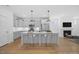 Spacious kitchen with a large central island, stainless steel appliances, light blue cabinets, and hardwood floors at 212 Aubey Ln, Wake Forest, NC 27587