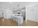 Modern kitchen with a large island, pendant lighting, stainless steel appliances at 212 Aubey Ln, Wake Forest, NC 27587