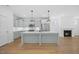 Open-concept kitchen and living area with an island, modern appliances, and stylish finishes at 212 Aubey Ln, Wake Forest, NC 27587