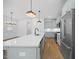 Bright kitchen with an island, stainless steel appliances, and pendant lighting at 212 Aubey Ln, Wake Forest, NC 27587