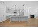 Stylish kitchen with a center island, stainless steel appliances, and open to the living room at 212 Aubey Ln, Wake Forest, NC 27587
