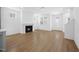 Bright living room featuring hardwood floors, fireplace, and access to other living areas at 212 Aubey Ln, Wake Forest, NC 27587