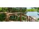 Wooden stairway through lush trees leading down to a serene lake, offering easy access for residents at 212 Aubey Ln, Wake Forest, NC 27587