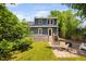 View of backyard with fire pit, patio and lush green space at 218 Lafayette Rd, Raleigh, NC 27604