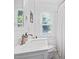 Bathroom with a marble-top vanity, classic faucet, and view from window at 218 Lafayette Rd, Raleigh, NC 27604