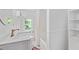 All-white bathroom featuring stylish fixtures, a bathtub and plenty of natural light at 218 Lafayette Rd, Raleigh, NC 27604