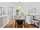 Bright dining room showcasing hardwood floors, decorative buffet, and ample natural light from the large window at 218 Lafayette Rd, Raleigh, NC 27604