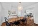 Elegant dining area featuring stylish lighting, a decorative buffet, and doorway to a living area with fireplace at 218 Lafayette Rd, Raleigh, NC 27604