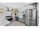 Modern kitchen with stainless steel appliances, white subway tile, and stylish tile flooring at 218 Lafayette Rd, Raleigh, NC 27604