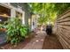 Side yard featuring a brick pathway and lush landscaping at 218 Lafayette Rd, Raleigh, NC 27604