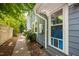 Side yard of home featuring lush landscaping and a brick pathway at 218 Lafayette Rd, Raleigh, NC 27604