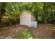 Backyard features a charming, well-maintained storage shed with a picket fence at 218 Lafayette Rd, Raleigh, NC 27604